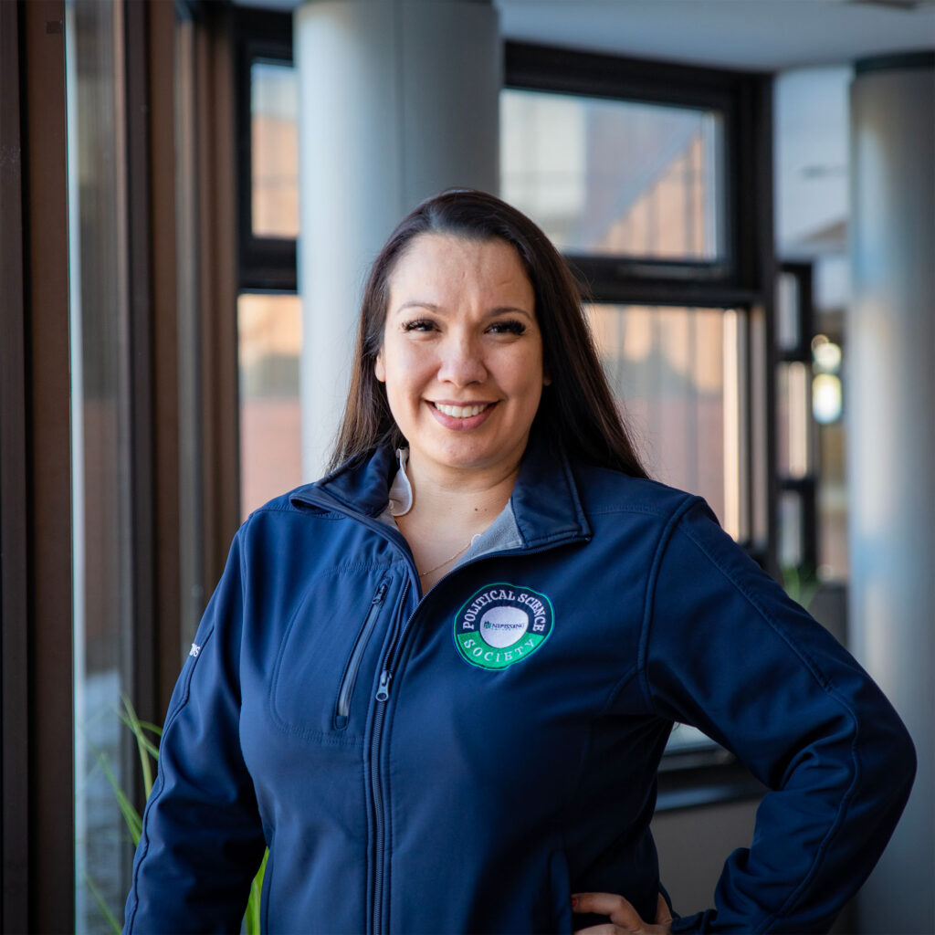 A woman in blue zip up in a well lit building background