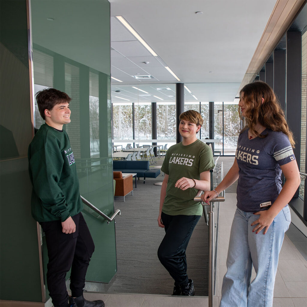3 students talking in the student centre in the winter